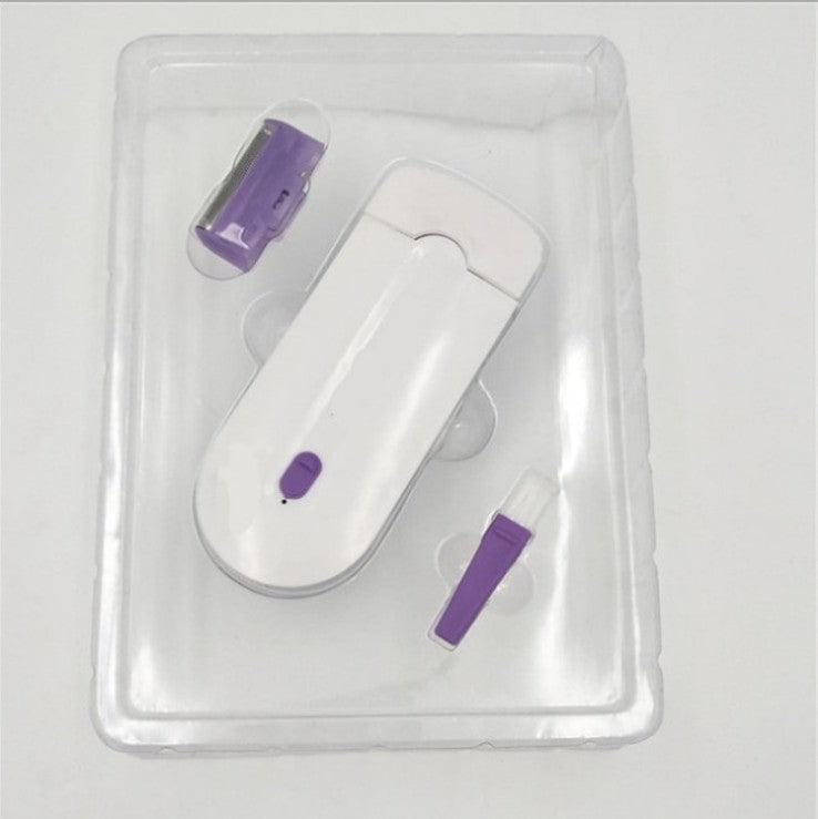 White and purple electronic device in clear packaging on a light gray background