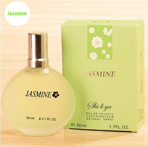 Shi Li Ya Jasmine perfume bottle and packaging on a light wooden background