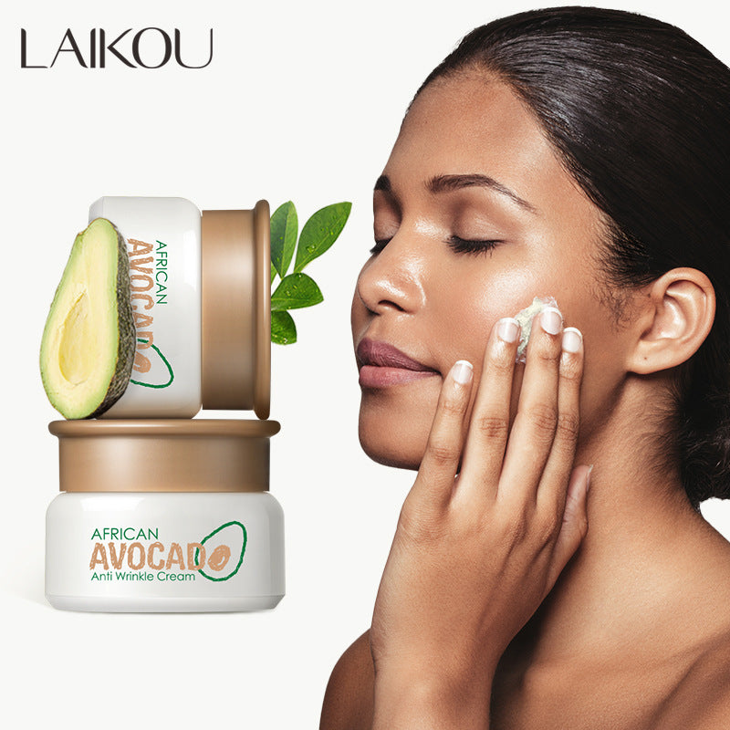 Woman applying cream to her face with Laikou African Avocado skincare products on a white background