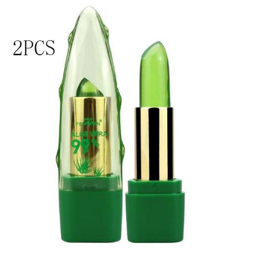 Two green lip balms with gold caps on a white background