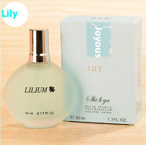 Perfume bottle and packaging with 'LILY' branding on a wooden surface