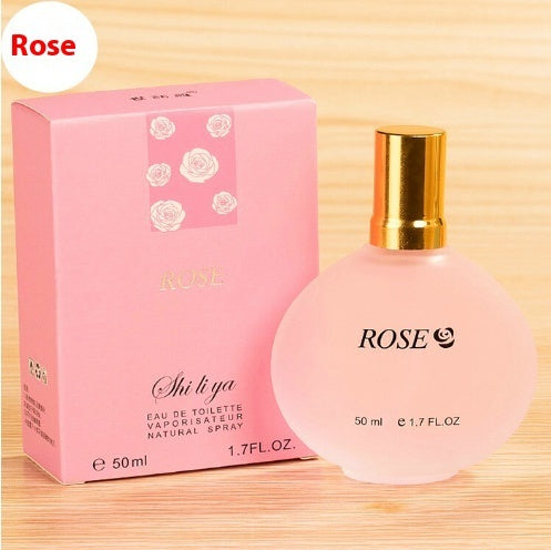 Shi Li Ya Rose perfume bottle and packaging on a wooden surface