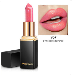 Pink lipstick with gold cap and black base, close-up of lips wearing the lipstick.