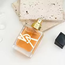 Perfume bottle with a gold cap on a white surface