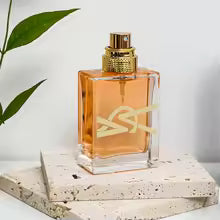 Perfume bottle with gold cap on a light background