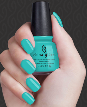 Hand with teal nail polish holding a bottle of China Glaze nail polish.